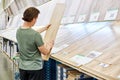 Man chooses floorboard laminate in store Royalty Free Stock Photo