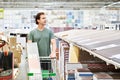 Man chooses floorboard laminate in store Royalty Free Stock Photo