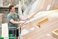 Man chooses floorboard laminate in store Royalty Free Stock Photo