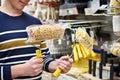 Man chooses paint rollers for repair in shop Royalty Free Stock Photo