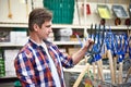 Man chooses pitchfork hay in store Royalty Free Stock Photo