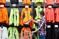 Man chooses sports clothes in store