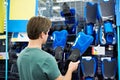 Man chooses swimfins for scuba diving in store Royalty Free Stock Photo