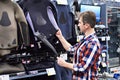 Man chooses wetsuit and fins for spearfishing in sports shop