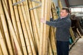 Man choosing bamboo stakes at gardening store Royalty Free Stock Photo