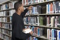 Man Choosing Book From A Shelf Royalty Free Stock Photo