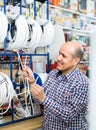 Man choosing cable in household store Royalty Free Stock Photo