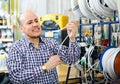 Man choosing cable in household store Royalty Free Stock Photo