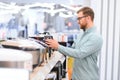 Man choosing crockpot at electric store Royalty Free Stock Photo