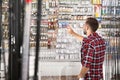 Man choosing fishing equipment in sports shop. Royalty Free Stock Photo