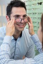 Man choosing glasses in optics store Royalty Free Stock Photo