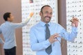 man choosing glasses in optics store Royalty Free Stock Photo