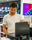 Man choosing hardware in electronics store Royalty Free Stock Photo