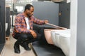 African american Man choosing home toilet in store Royalty Free Stock Photo