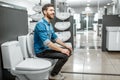 Man choosing lavatory pan in the shop Royalty Free Stock Photo