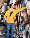 Man choosing new shovel in garden equipment shop Royalty Free Stock Photo