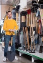 Man choosing new shovel in garden equipment shop Royalty Free Stock Photo