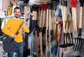 Man choosing new shovel in garden equipment shop Royalty Free Stock Photo