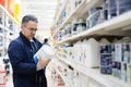 Man choosing paint on the shelves of a hardware store Royalty Free Stock Photo