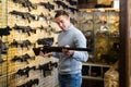 Man choosing sniper rifle in arms shop