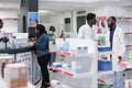 Man choosing vitamins in drugstore, woman buying prescription treatment Royalty Free Stock Photo