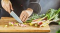 Man chopping fresh rhubarb chard or Swiss chard