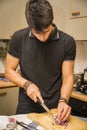 Man Chopping Red Onion with Sharp Knife in Kitchen