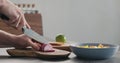 Man chopping red onions on olive wood board for greek salad Royalty Free Stock Photo