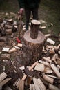 A man chopping wood with an ax in his hand. Standing by a log for chopping wood. Royalty Free Stock Photo