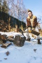 Man chopping wood with an axe, pieces and debris flying around Royalty Free Stock Photo