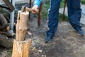 Man chopping wood in the backyard. Lumberjack cuts logs