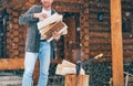 Man chopping wood on snowy yard for a house fireplace with heavy snowflakes background . Winter countryside holidays concept image Royalty Free Stock Photo