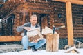 Man chopping wood on snowy yard for a house fireplace with heavy snowflakes background . Winter countryside holidays concept image Royalty Free Stock Photo