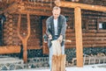 Man chopping wood on snowy yard for a house fireplace with heavy snowflakes background . Winter countryside holidays concept image Royalty Free Stock Photo