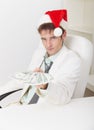 Man in Christmas hat gives us money Royalty Free Stock Photo
