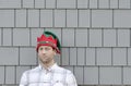 Man in a Christmas hat looking to the side with a smirk. Royalty Free Stock Photo