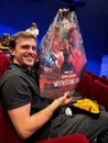 Podgorica, Montenegro - 25.08.22: Man in a cinema with a poster for the movie Doctor Strange in his hands