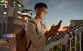 Man, city night and phone text of a student on social media app, internet or web search. Black man with mobile Royalty Free Stock Photo