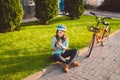 Man and city rolling bicycle, environmentally friendly transport. Beautiful young caucasian woman worker sitting resting on the gr Royalty Free Stock Photo