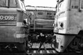 A man clamped in a Vice between two cars. Black-and-white photo of a man constrained by circumstances. The guy on the tracks is