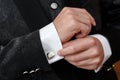 man clasps a cuff link on a shirt Royalty Free Stock Photo