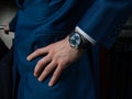 A man in a classic suit with a clock on his hand holds his hand on his belt Royalty Free Stock Photo