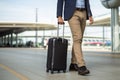 Man in classic suit with luggage goes to airport about to fly to business meeting on business trip