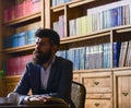 Man in classic suit sits in vintage interior, library, Royalty Free Stock Photo