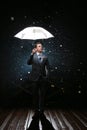 Man in classic suit with white umbrella in flash lights and rain drops Royalty Free Stock Photo