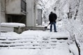 Man clean icy strains and sidewalk