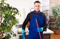 Man cleaner with mop standing in office Royalty Free Stock Photo