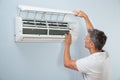 Man cleaning air conditioning system Royalty Free Stock Photo