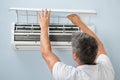 Man cleaning air conditioning system Royalty Free Stock Photo