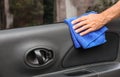 Man cleaning automobile door with duster, closeup Royalty Free Stock Photo